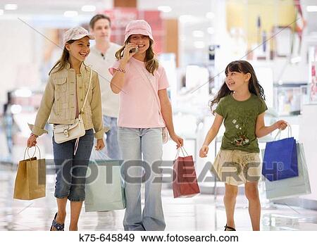caucasians, hispanic, ages 9 and 10, shopping, talking on cell phone, laughing, smiling, department store, mall, young consumers View Large Photo Image Stock Photo - caucasians, hispanic, ages 9 and 10, shopping, talking on cell phone, laughing, smiling, department store, mall, young consumers. Fotosearch