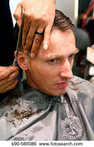 Caucasion man at hairdresser with hairdresser cutting his blond hair View Large Photo Image Stock Photograph - Caucasion man at hairdresser with hairdresser cutting his blond hair. Fotosearch
