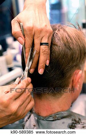 Caucasion man at hairdresser with hairdresser cutting his blond hair View Large Photo Image Stock Photography - Caucasion man at hairdresser with hairdresser cutting his blond hair. Fotosearch