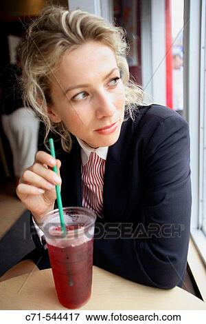 Caucassian businesswoman looking into the future at cafe with cool drink View Large Photo Image Stock Photo - Caucassian businesswoman looking into the future at cafe with cool drink. Fotosearch