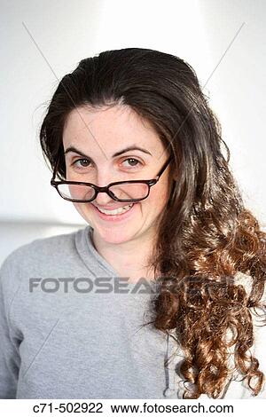 Caucassian nerdy woman with glasses on tip of nose View Large Photo Image Stock Image - Caucassian nerdy woman with glasses on tip of nose. Fotosearch
