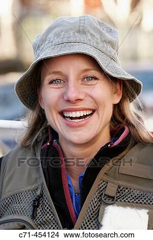 Caussian woman in fishing outfit and fishing pole smiling View Large Photo Image Picture - Caussian woman in fishing outfit and fishing pole smiling. Fotosearch