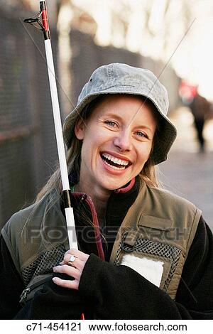 Caussian woman in fishing outfit and fishing pole smiling View Large Photo Image Stock Image - Caussian woman in fishing outfit and fishing pole smiling. Fotosearch