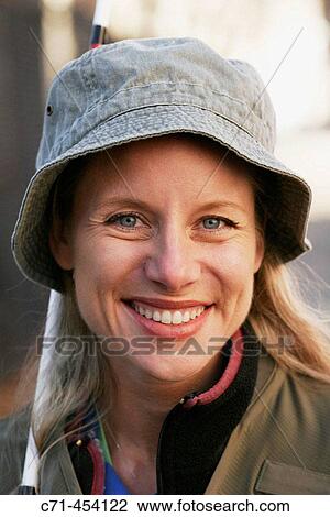 Caussian woman in fishing outfit and fishing pole smiling View Large Photo Image Stock Image - Caussian woman in fishing outfit and fishing pole smiling. Fotosearch