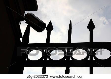 Stock Image - cctv camera above gate entrance in rome italy.. Fotosearch