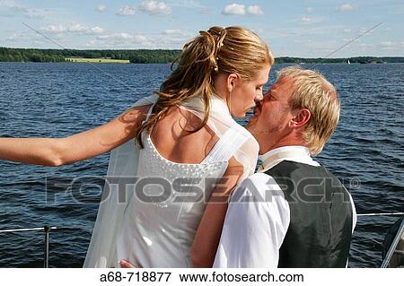 Celebrating the wedding with a kiss Model release View Large Photo Image Stock Photo - Celebrating the wedding with a kiss Model release. Fotosearch