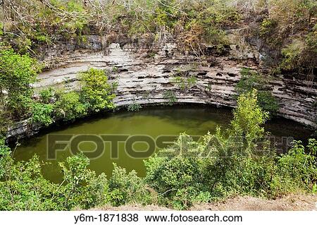 Stock Photo - Cenote Sagrado Sacred Well at Chichen Itza, Yucatan Peninsula, Quintana Roo, Mexico. Fotosearch