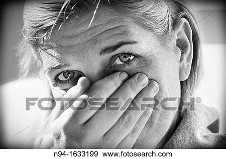 Central European woman portrait with hand on her mouth and looking at the camera View Large Photo Image Stock Photo - Central European woman portrait with hand on her mouth and looking at the camera. Fotosearch