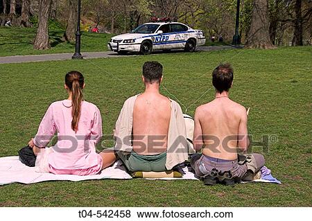 Central Park. People meditating under watch of a NYPD vehicle. New York City. USA. View Large Photo Image Stock Photo - Central Park. People meditating under watch of a NYPD vehicle. New York City. USA.. Fotosearch