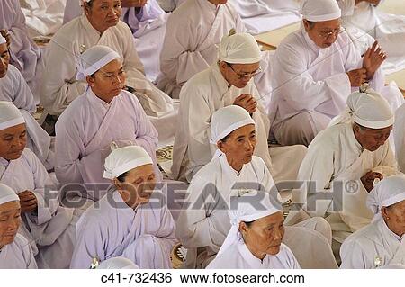 Stock Photograph - Ceremony in Cao Dai temple, Tay Ninh, Vietnam. Fotosearch