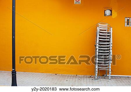 Chairs and orange wall in Valencia city, Spain View Large Photo Image Stock Image - Chairs and orange wall in Valencia city, Spain. Fotosearch