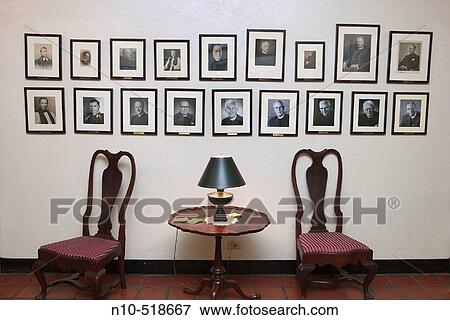 Chairs, table with a lamp, and portraits on the wall in a church lobby View Large Photo Image Stock Photo - Chairs, table with a lamp, and portraits on the wall in a church lobby. Fotosearch