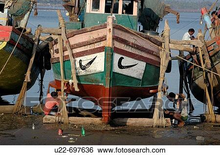 Stock Photograph - Chapora, Goa India: a fishing boat repainted at the local beach. Fotosearch