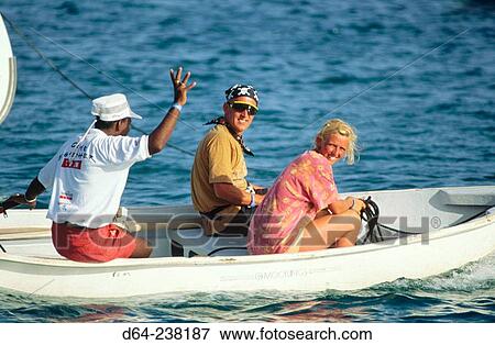 Stock Photo - Charter boat sailors in dinghy - British Virgin Islands, Caribbean. Fotosearch