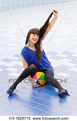 Cheerful young woman pulling hair View Large Photo Image Stock Photography - Cheerful young woman pulling hair. Fotosearch
