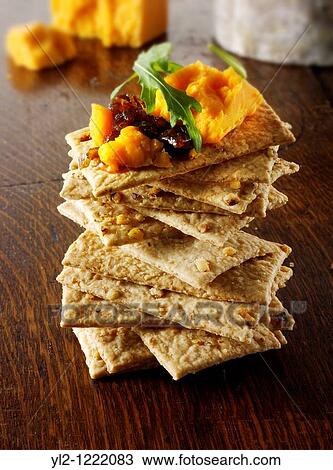 Stock Image - Cheese and biscuits with Red Leicester cheese. Fotosearch