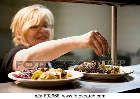Chef garnishing plates at restaurant, Germany View Large Photo Image Stock Photo - Chef garnishing plates at restaurant, Germany. Fotosearch