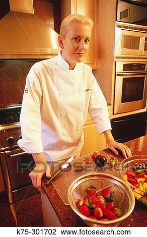 Stock Image - Chef in her kitchen. Fotosearch