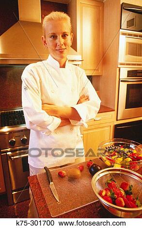 Stock Image - chef in her professional kitchen. Fotosearch