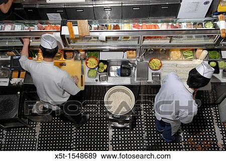 Stock Photo - Chef prepares Sushi in a sushi restaurant. Fotosearch