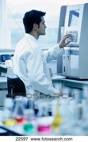 Stock Photo - Chemical lab. Chemist using a LECO CS400 automatic carbon/sulphur determinator. Fotosearch