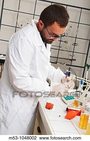 Stock Image - chemist at work in a chemical lab. Fotosearch