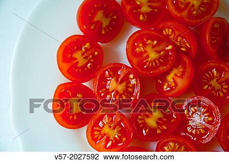 Stock Image - Cherry tomatoes on a dish. Close view.. Fotosearch