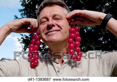 cherry tomatoes vine with man View Large Photo Image Stock Photo - cherry tomatoes vine with man. Fotosearch
