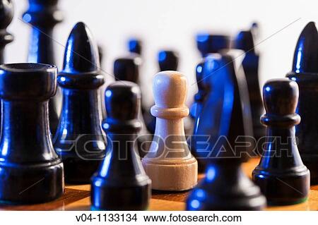 Chess pieces: white pawn faces black chess pieces View Large Photo Image Picture - Chess pieces: white pawn faces black chess pieces. Fotosearch