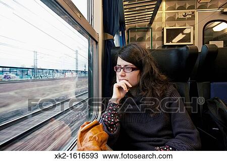 Chica mirando por la ventana de un tren View Large Photo Image Stock Image - Chica mirando por la ventana de un tren. Fotosearch