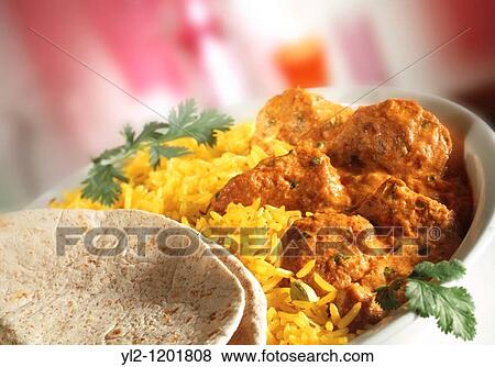Stock Photo - Chicken Madras - Pilau rice & naan bread in white dish with red background. Fotosearch