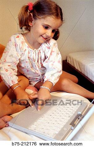 Stock Photograph - Child and laptop computer. Fotosearch