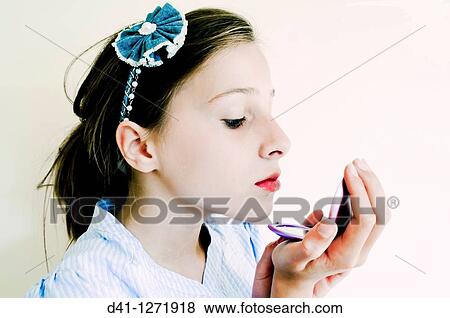 Child applying makeup View Large Photo Image Stock Photo - Child applying makeup. Fotosearch
