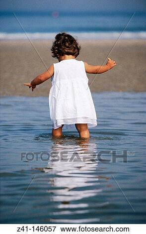 Child at the beach View Large Photo Image Stock Photo - Child at the beach. Fotosearch