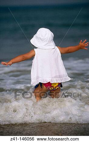 Child at the beach View Large Photo Image Stock Photograph - Child at the beach. Fotosearch