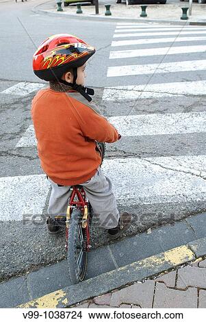 Picture - child biking respecting the highway code. Fotosearch