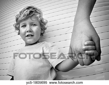 Child by the hand of his father View Large Photo Image Stock Photography - Child by the hand of his father. Fotosearch