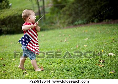 Child carrying an American flag View Large Photo Image Picture - Child carrying an American flag. Fotosearch