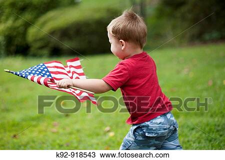 Child carrying an American flag View Large Photo Image Stock Image - Child carrying an American flag. Fotosearch