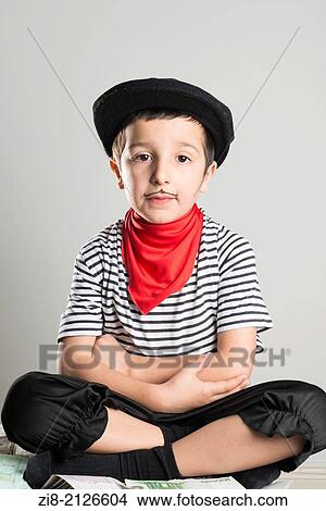 Child dressed as a robber with a stripy top, black hat and badly drawn moustache. View Large Photo Image Picture - Child dressed as a robber with a stripy top, black hat and badly drawn moustache.. Fotosearch