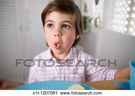 Stock Image - Child eating.. Fotosearch