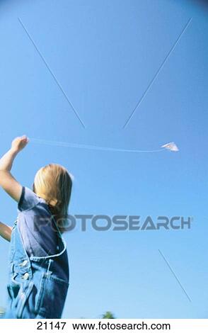 Child flying kite View Large Photo Image Stock Photo - Child flying kite. Fotosearch