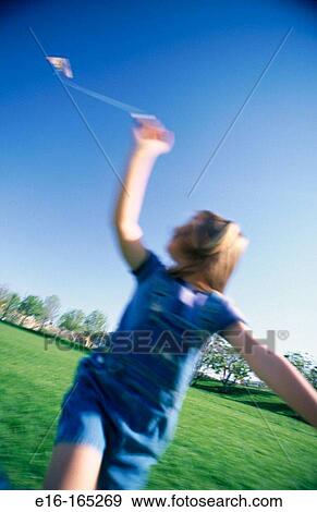 Child flying kite View Large Photo Image Stock Photo - Child flying kite. Fotosearch