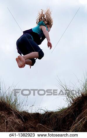 child girl jumping from sand dune View Large Photo Image Stock Image - child girl jumping from sand dune. Fotosearch