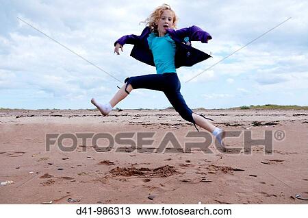 child girl leaping over beach View Large Photo Image Stock Image - child girl leaping over beach. Fotosearch