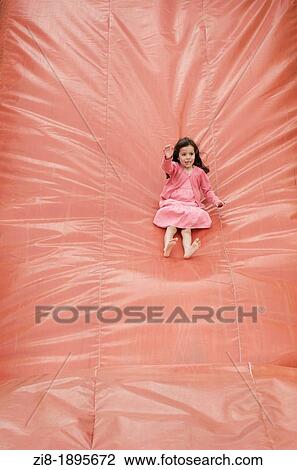 Child having fun on a bouncy slide View Large Photo Image Stock Image - Child having fun on a bouncy slide. Fotosearch