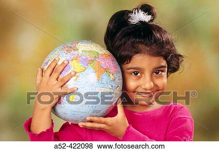 Stock Photo - Child holding globe showing India.. Fotosearch