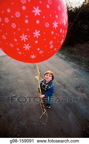 Child holding red balloon View Large Photo Image Stock Image - Child holding red balloon. Fotosearch