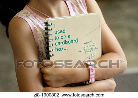 Stock Image - Child holds notebook made out of recycled paper-close-up. Fotosearch