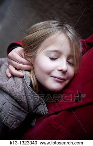 Stock Image - Child hugging her mother. Fotosearch